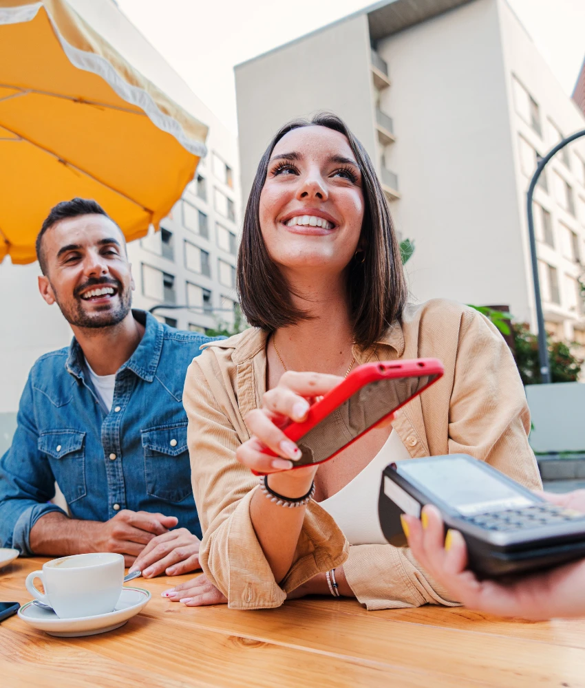 Un couple heureux paie au restaurant et montre des problèmes d'argent opposés