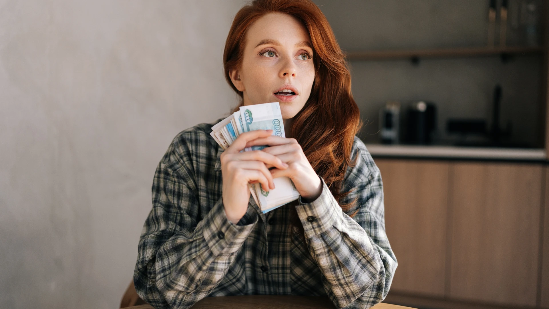 femme détenant de l'argent après avoir changé ses habitudes de dépenses