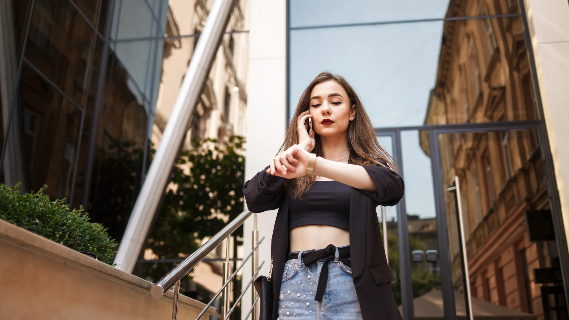 Une femme occupée au téléphone vérifie sa montre montrant un trait peu sympathique