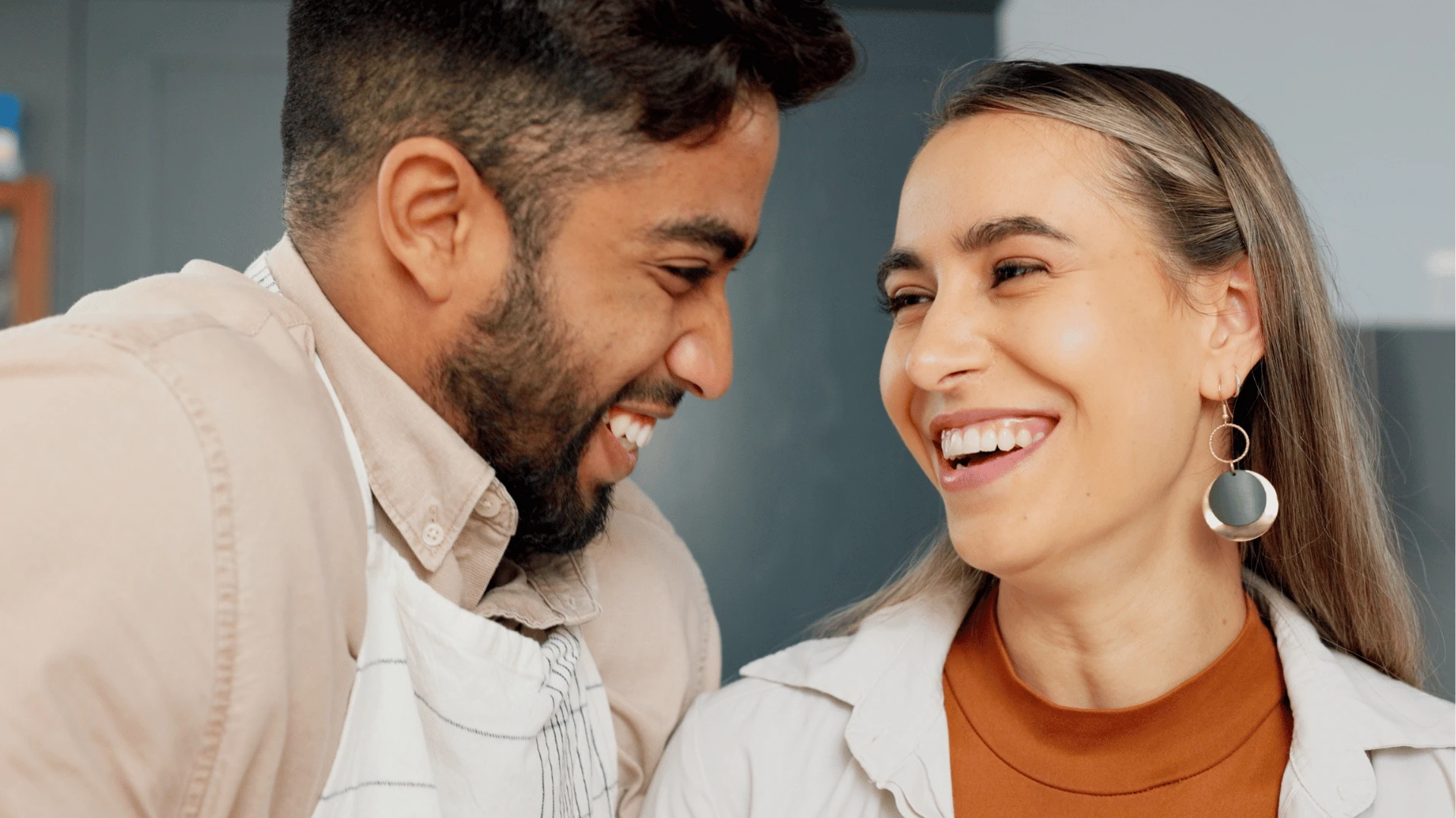 Un couple exceptionnellement intelligent se tient proche l'un de l'autre et sourit et rit ensemble 
